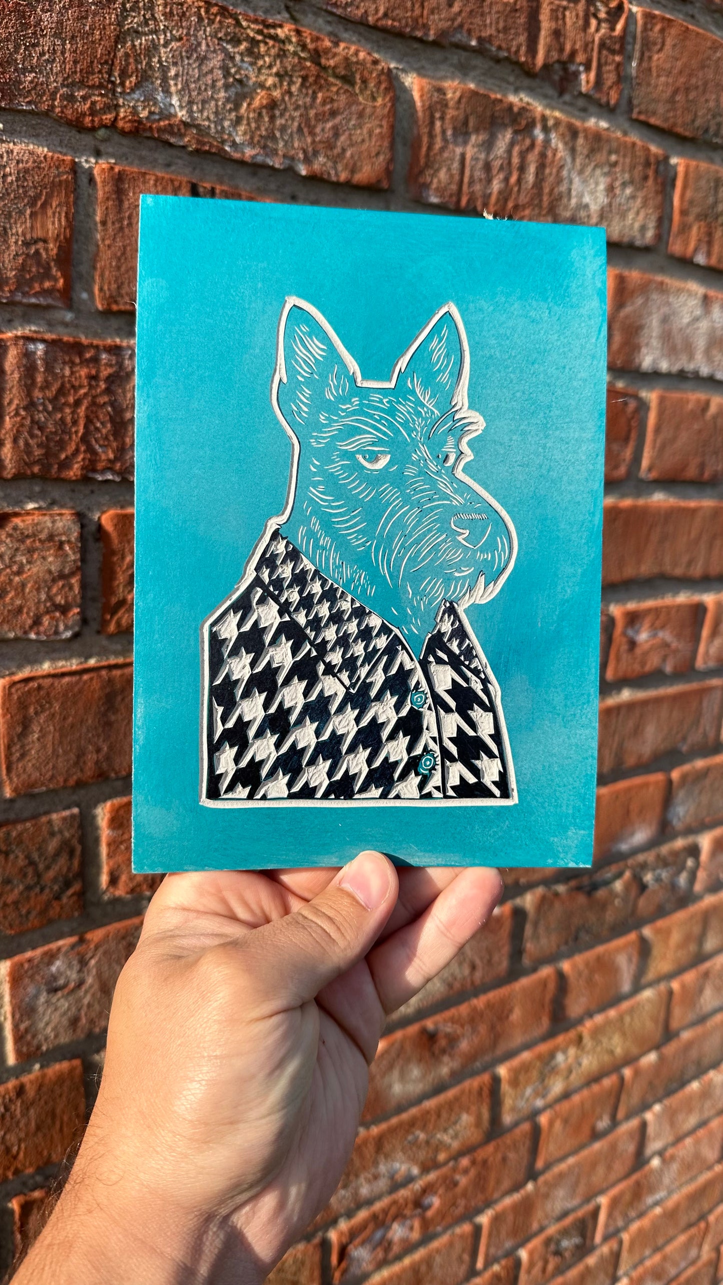linocut block of a scottish terrier wearing clothing with a houndstooth pattern - perfect gift for dog lovers.