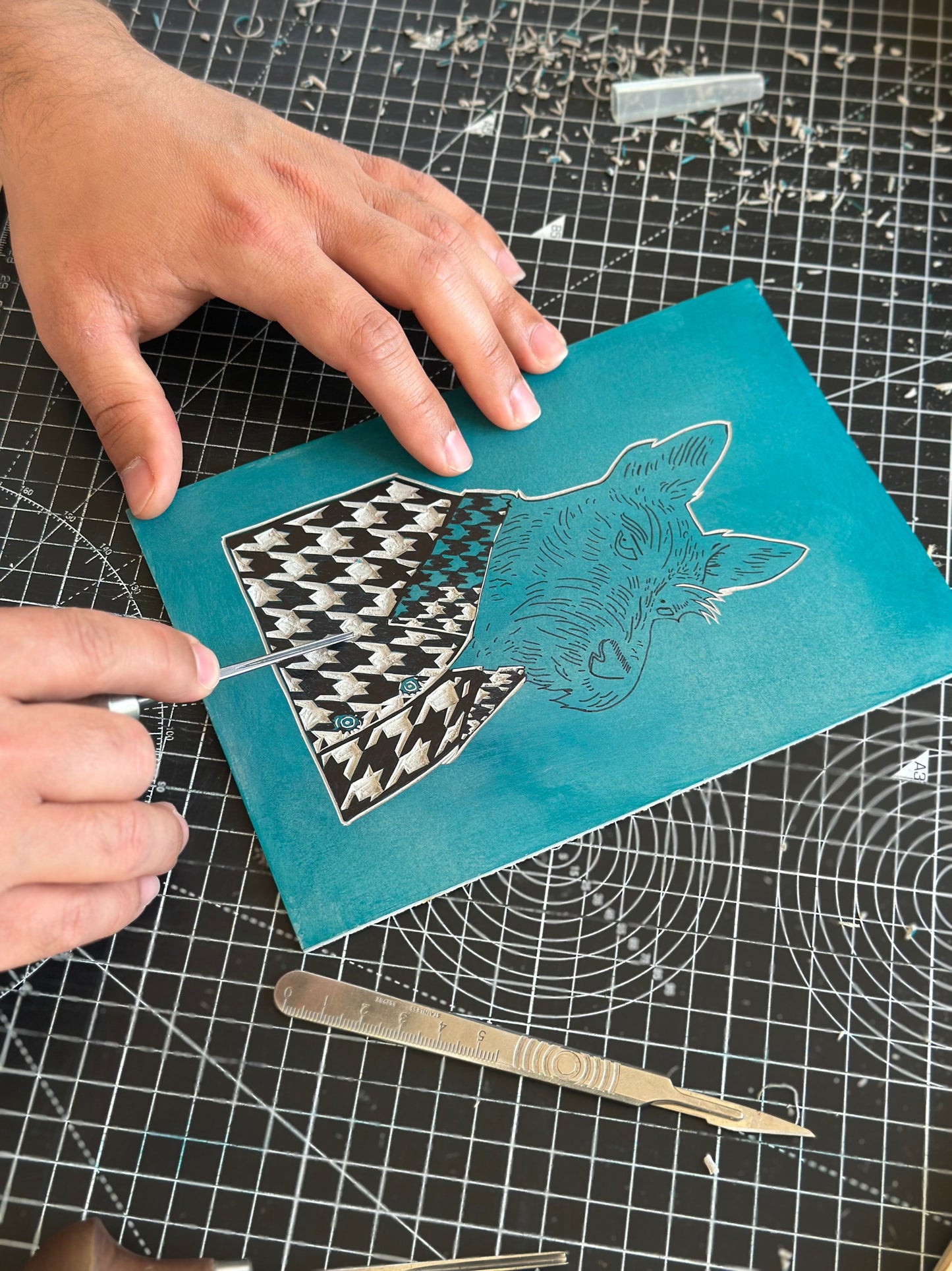 linocut block of a scottish terrier print being carved