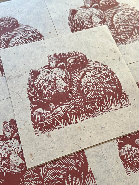 Print of a mother bear and her cub on textured natural paper.