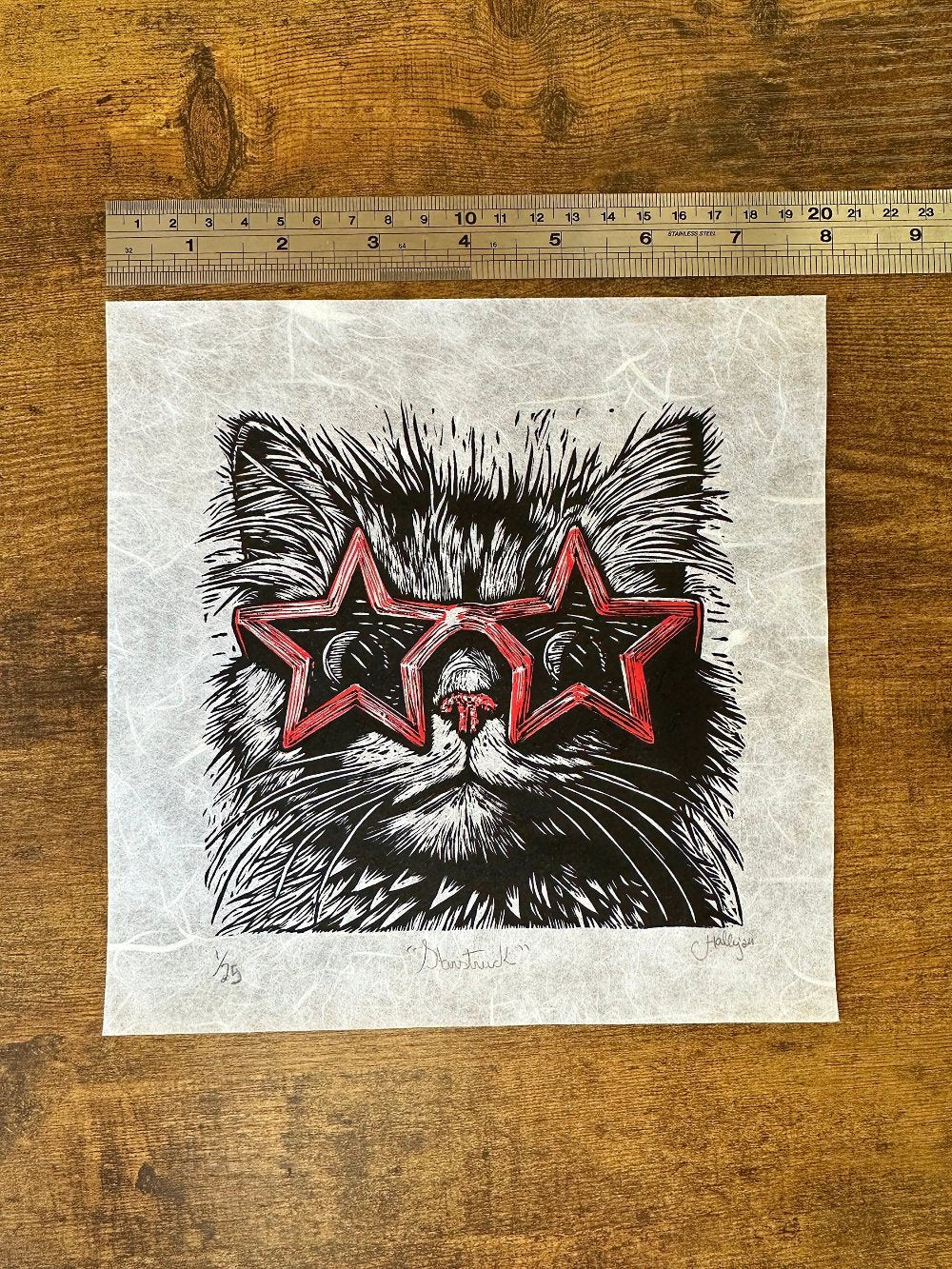 Linocut print of a cat wearing star shaped red sunglasses, very fine detail and the perfect gift for cat lovers.