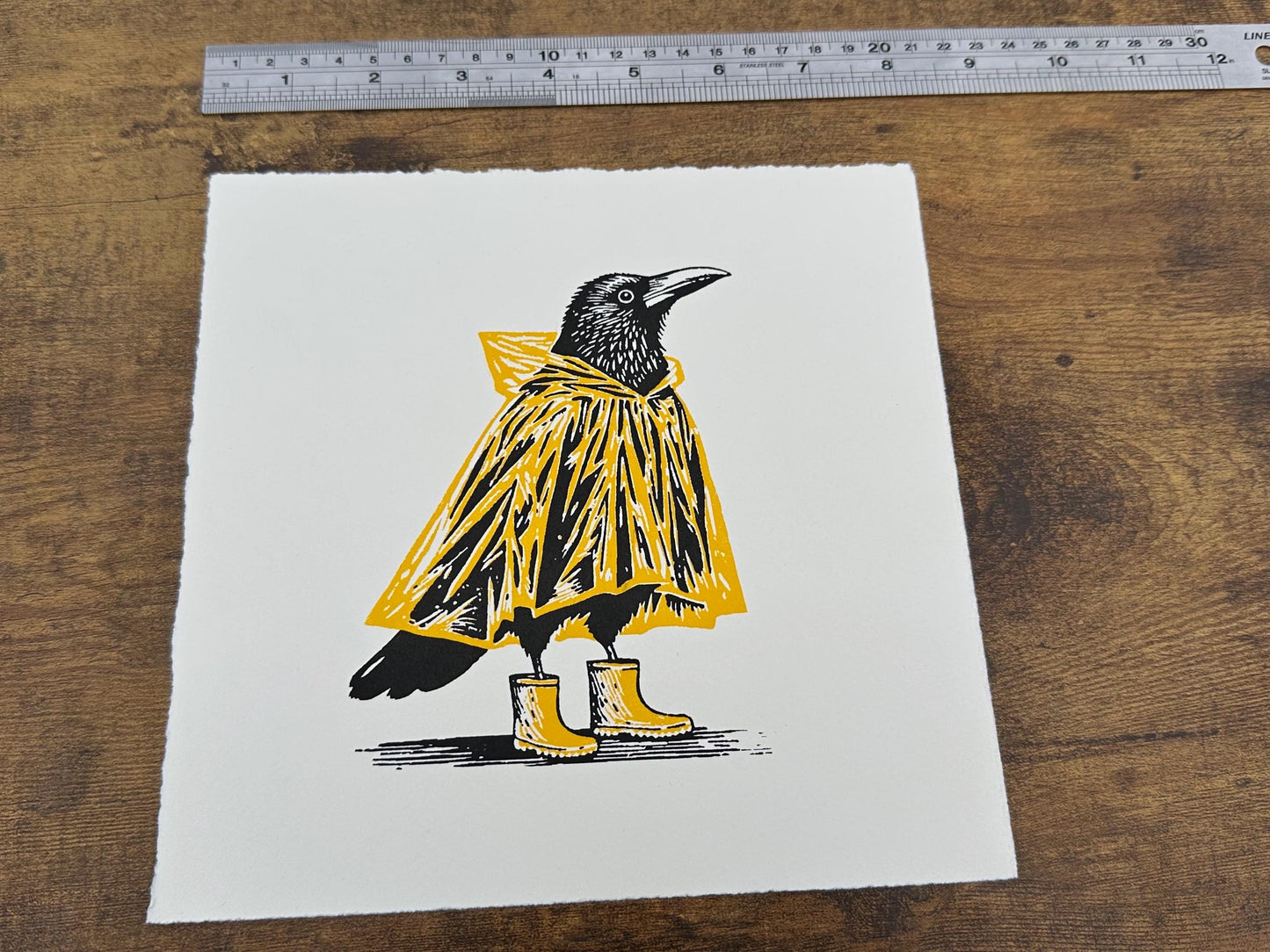 Mac & Wellies - Original Handmade Linocut Print of a Crow in a Yellow Raincoat and Wellington Boots.