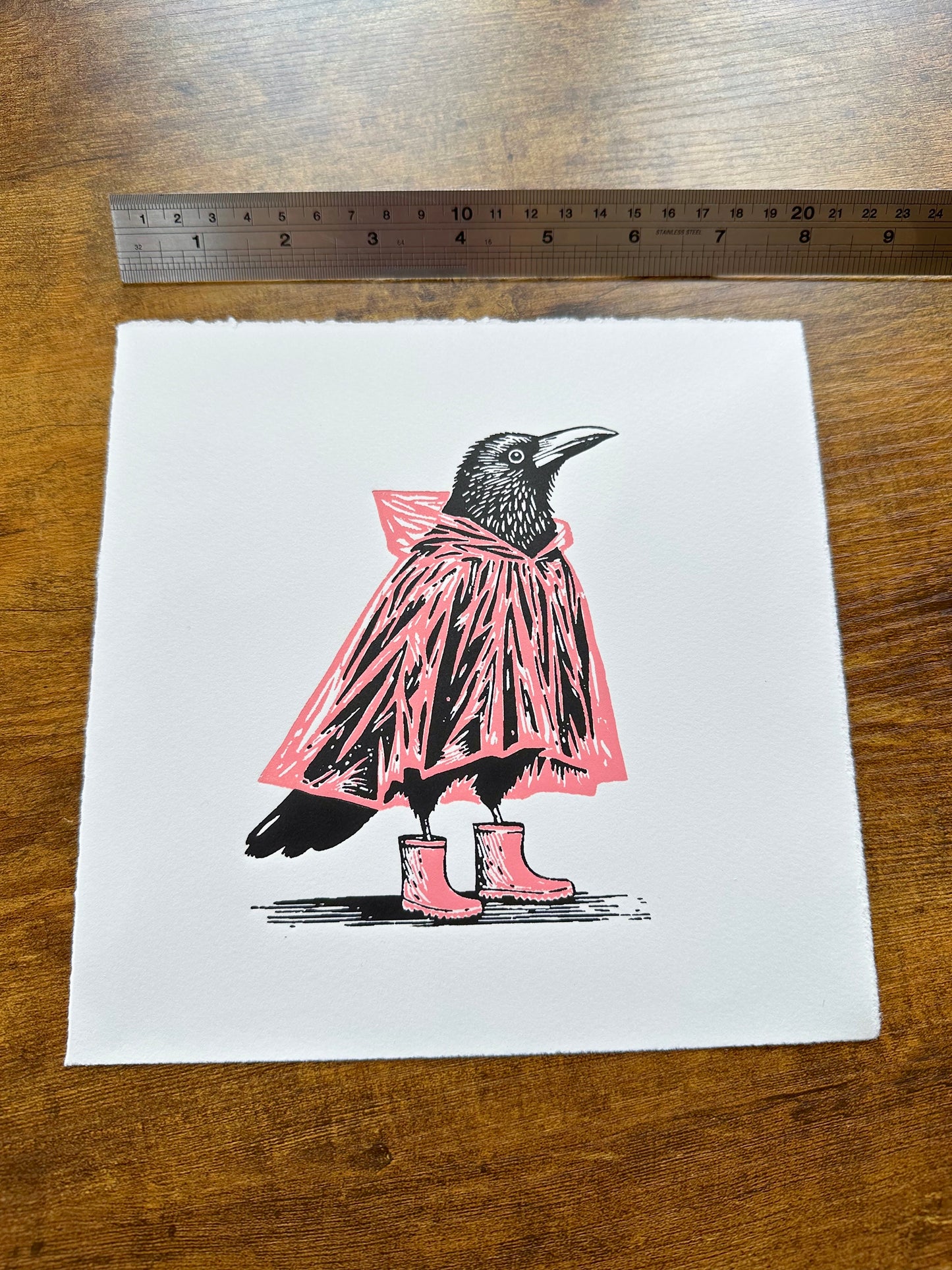 Mac & Wellies - Original Handmade Linocut Print of a Crow in a PINK Raincoat and Wellington Boots.