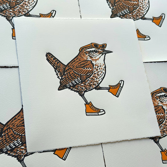 bird linocut print of a wren wearing sunglasses and orange sneakers on a white background