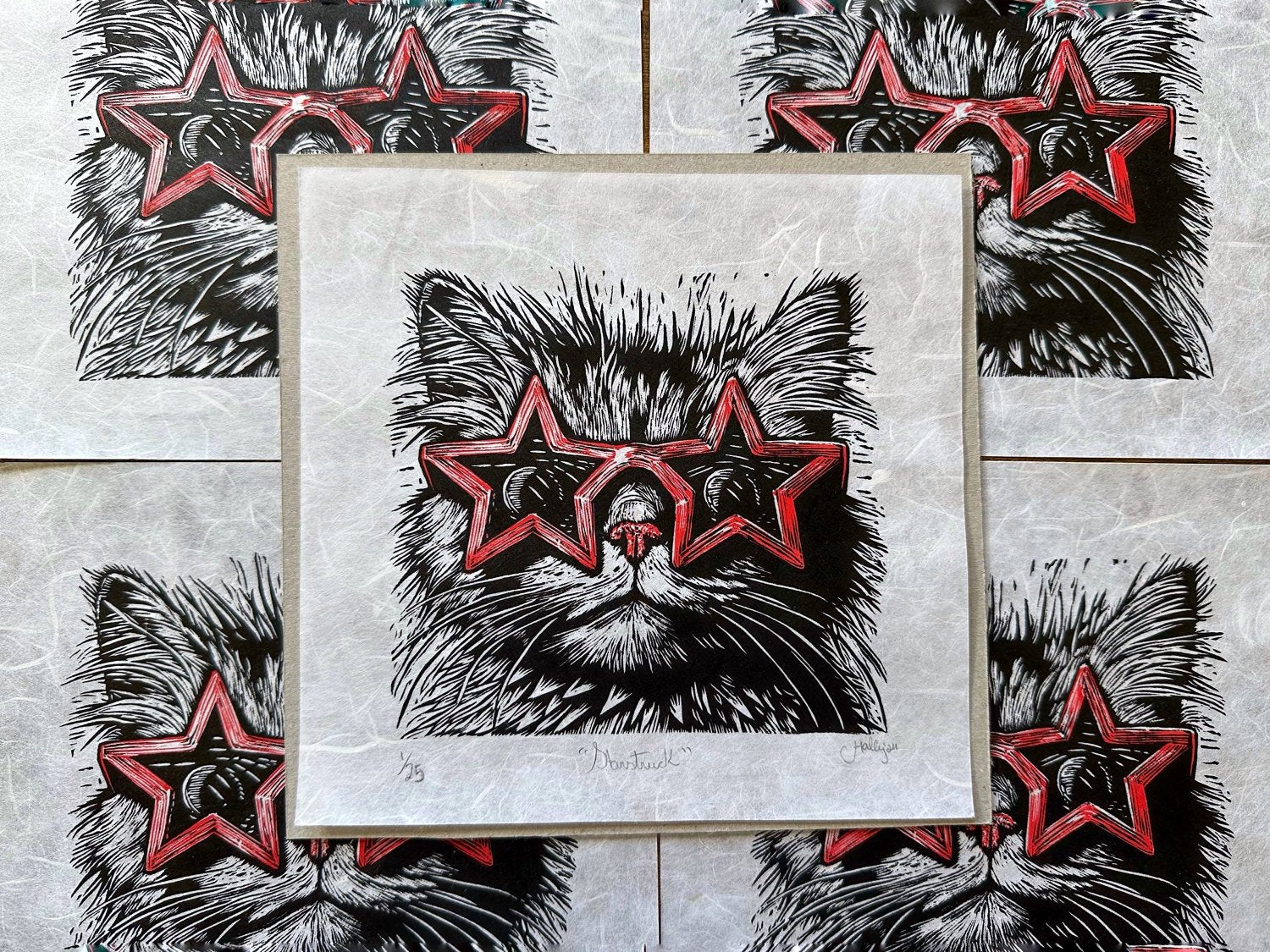 Linocut print of a cat wearing star shaped red sunglasses, very fine detail and the perfect gift for cat lovers.